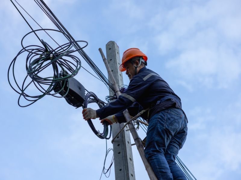 Telecom technician performing pole data collection and aerial OSP survey Telecom permit design drawings for ROW approvals